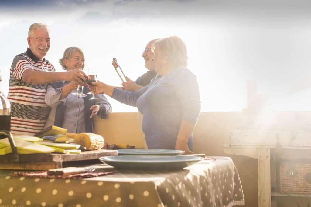 Friends enjoying dinner from an outdoor kitchen.